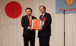蘇成宗會長(左)贈送紀念品給僑務委員長(右)，以表達謝意
